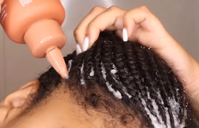girl applying shampoo into the scalp